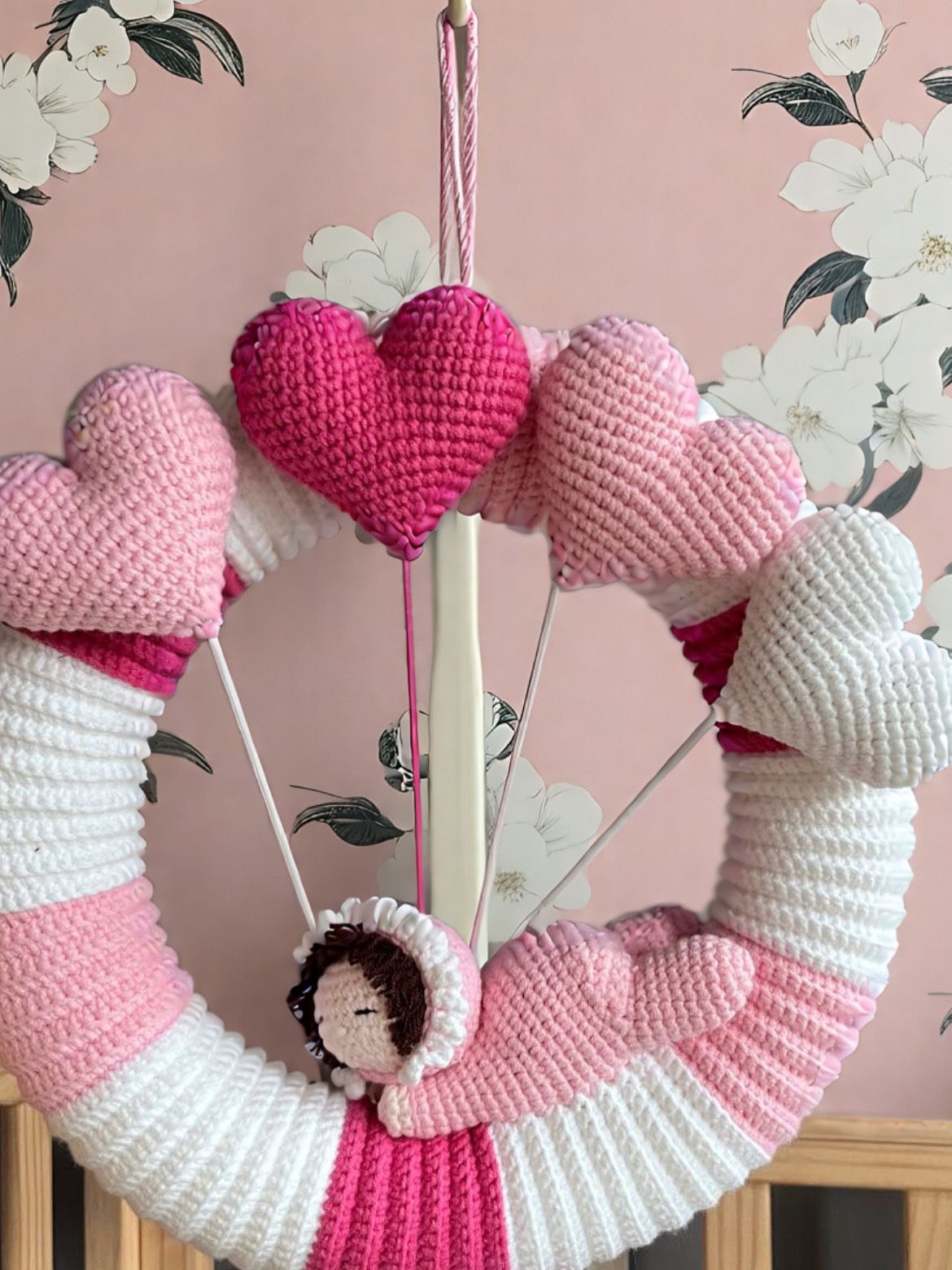 This adorable crochet baby-themed decoration in pink and white is perfect for adding a touch of sweetness to your home Made with love, this handmade piece features a baby face and heart details, making it a lovely decor for a nursery, living room,
